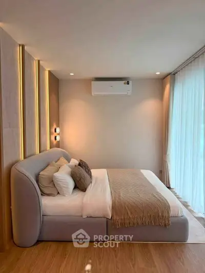 Luxurious bedroom with modern design and ambient lighting, featuring a cozy bed and elegant decor.