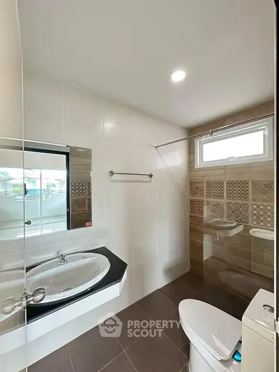 Modern bathroom with stylish tiles and sleek fixtures in a contemporary home.