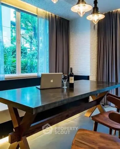 Modern study room with sleek wooden table, elegant lighting, and large window view.