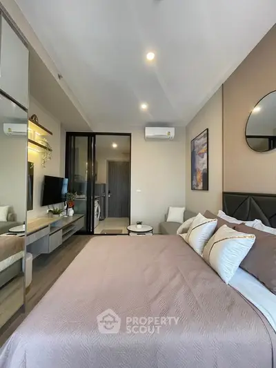 Modern bedroom with stylish decor and cozy ambiance in a contemporary apartment.