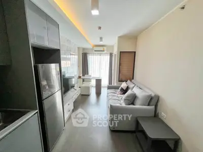 Modern living room with sleek design, featuring a cozy sofa, flat-screen TV, and natural light from large windows.