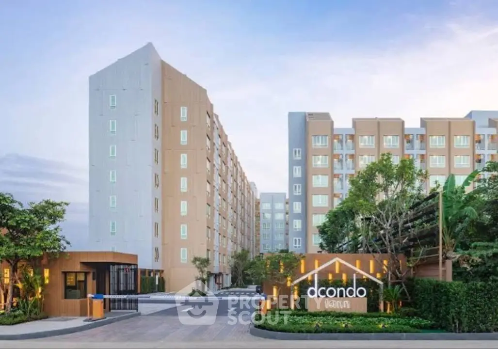 Modern condominium building exterior with lush landscaping and welcoming entrance.