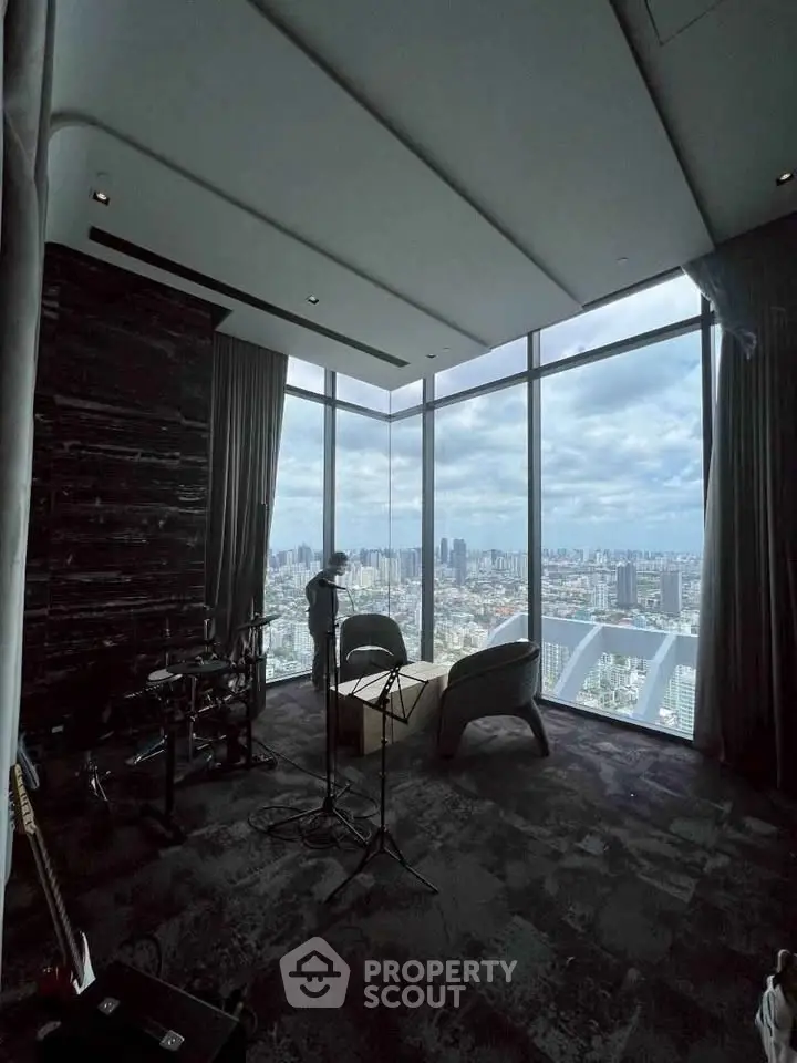 Luxurious high-rise living room with panoramic city views and modern decor.