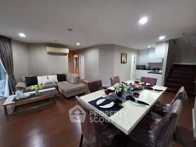 Spacious open-plan living and dining area with modern furnishings and elegant decor.
