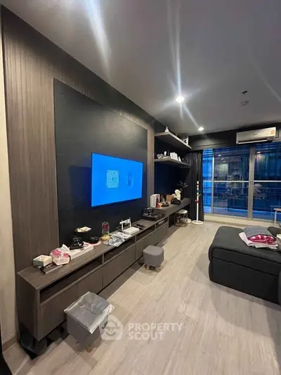 Modern living room with sleek entertainment center and large window view.
