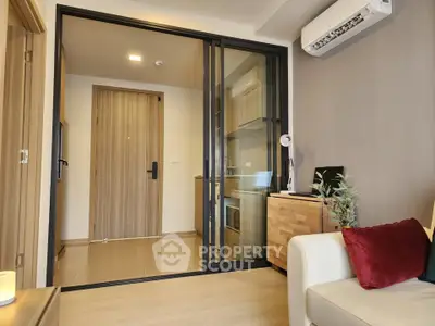 Modern apartment interior with sliding glass doors, air conditioning, and stylish decor.