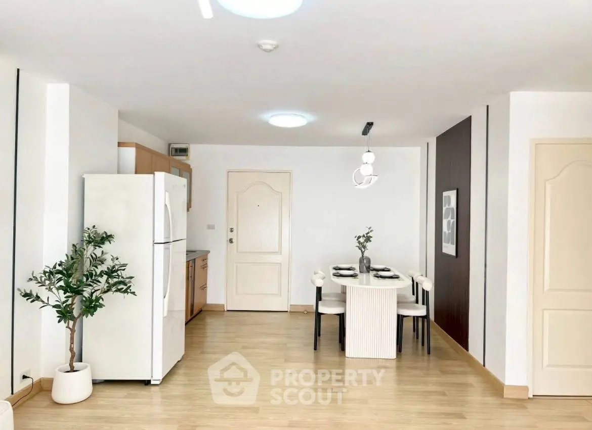 Spacious modern kitchen with dining area and sleek appliances in a bright open layout.