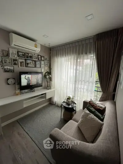 Cozy living room with modern decor and large window for natural light