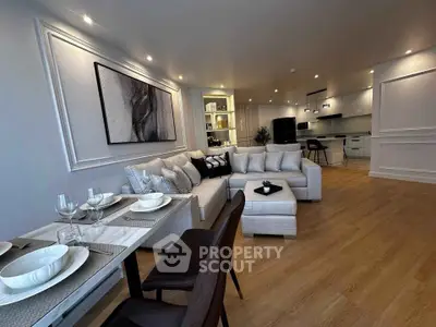 Luxurious open-plan living room with elegant decor and modern kitchen