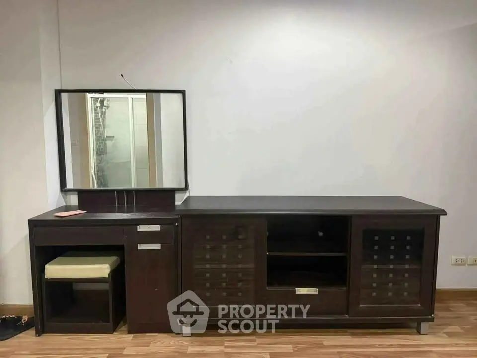 Elegant dark wood vanity set with mirror and storage in a modern interior
