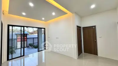 Modern living room with sleek design and large sliding doors opening to a patio.