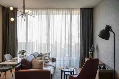 Modern living room with elegant decor and large window view