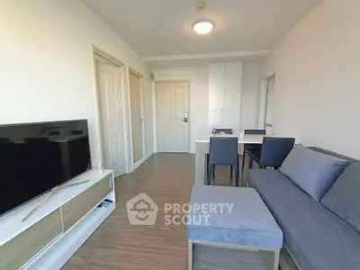 Modern living room with sleek furniture and wooden flooring in a cozy apartment.
