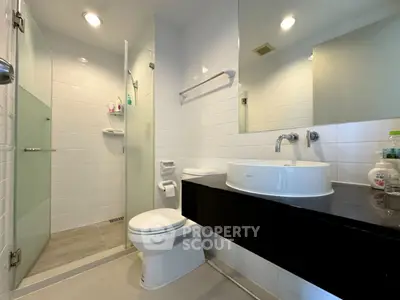 Modern bathroom with sleek fixtures and glass shower enclosure