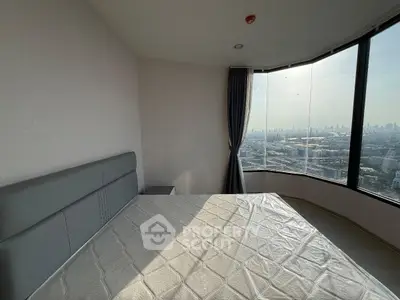 Spacious bedroom with panoramic city view and modern furnishings