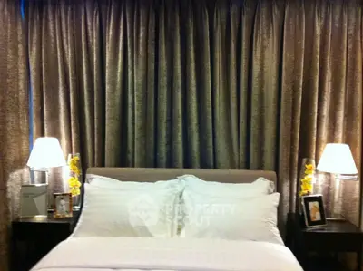 Luxurious bedroom with elegant curtains and ambient lighting for a cozy atmosphere.