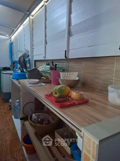 Charming kitchen with wooden countertops and ample storage, perfect for culinary enthusiasts.