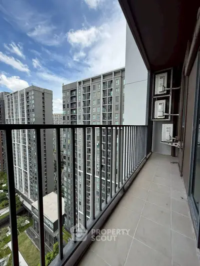 Spacious balcony with stunning cityscape view in modern high-rise apartment