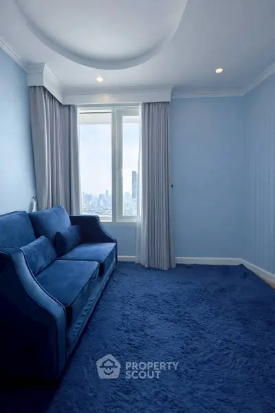 Elegant blue living room with plush carpet and city view window