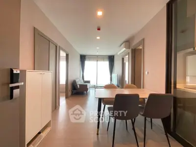 Spacious modern living room with dining area and natural light, perfect for urban living.
