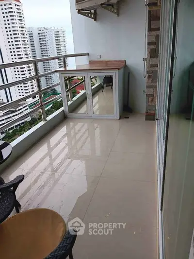 Spacious balcony with city view in modern high-rise apartment