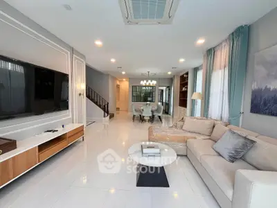 Spacious modern living room with elegant decor and open dining area