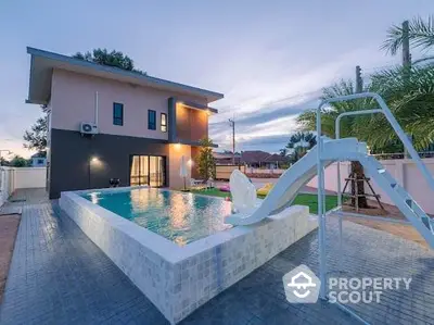 Modern home with a stylish pool and slide, perfect for family fun and relaxation.