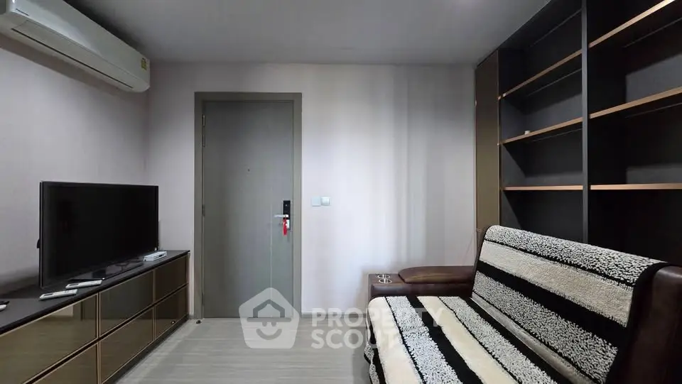 Modern living room with sleek furniture and built-in shelving, perfect for urban living.