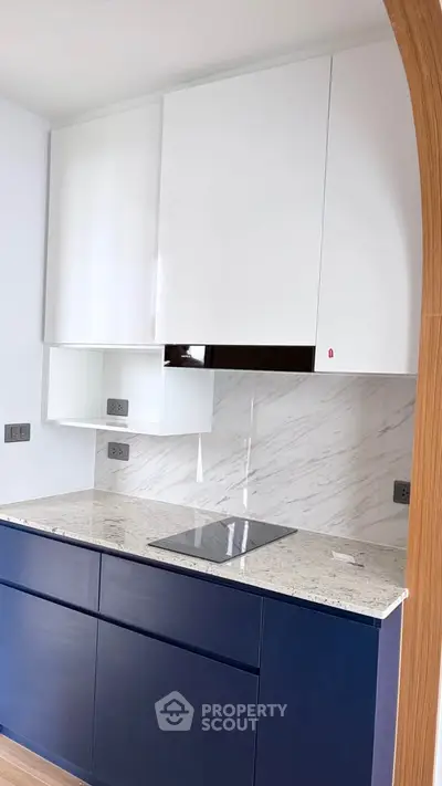 Modern kitchen with sleek cabinetry and marble backsplash