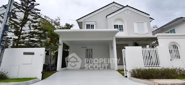 Elegant white two-story house with spacious driveway and modern design.