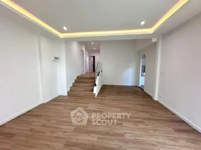 Spacious modern living room with elegant wooden flooring and recessed lighting