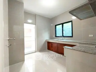 Modern kitchen with sleek countertops and ample natural light