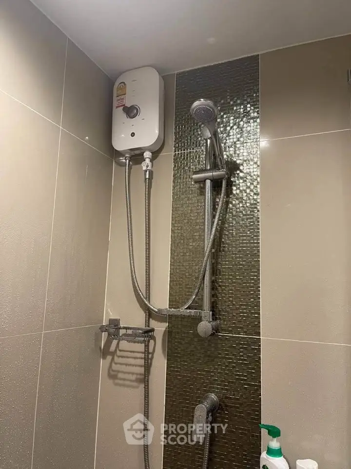 Modern bathroom with sleek shower fixtures and water heater, ideal for contemporary living.