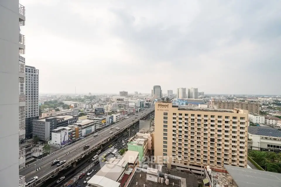 Stunning cityscape view from high-rise building overlooking bustling urban landscape.
