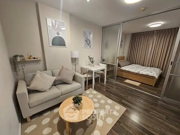 Modern studio apartment with cozy living area and stylish bedroom