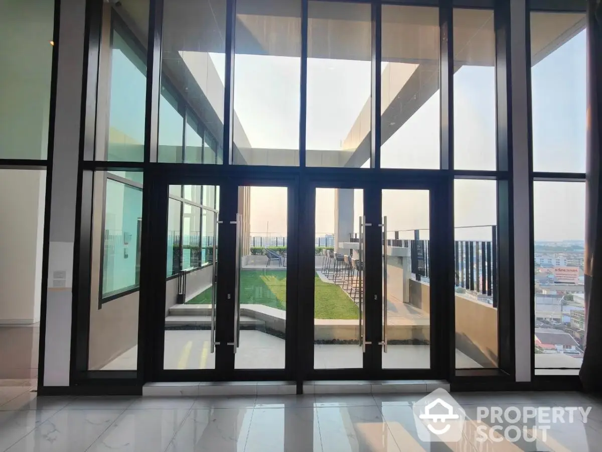 Luxurious modern entrance with floor-to-ceiling windows and stunning city view