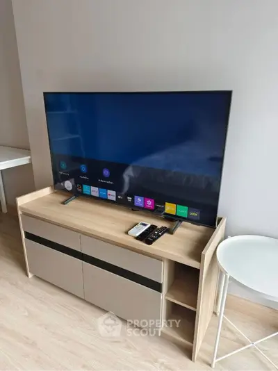 Modern living room with sleek TV setup and stylish wooden cabinet