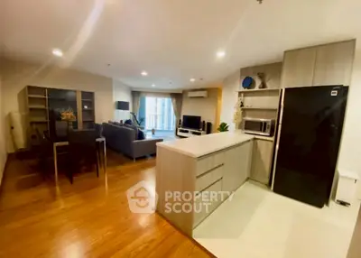 Spacious open-plan kitchen and living room with modern appliances and stylish decor.