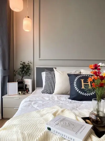 Stylish bedroom with modern decor, cozy bedding, and elegant lighting for a serene ambiance.