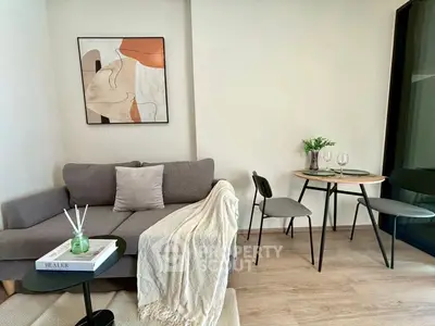 Modern living room with cozy sofa, stylish decor, and dining area in a chic apartment.