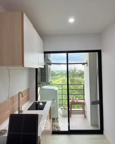 Modern kitchen with sleek design and balcony view