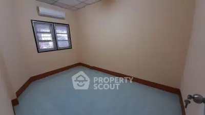 Spacious empty room with air conditioning and tiled flooring, perfect for customization.
