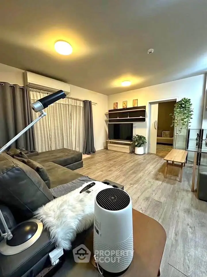 Spacious living room with modern decor and cozy seating area, perfect for relaxation and entertainment.