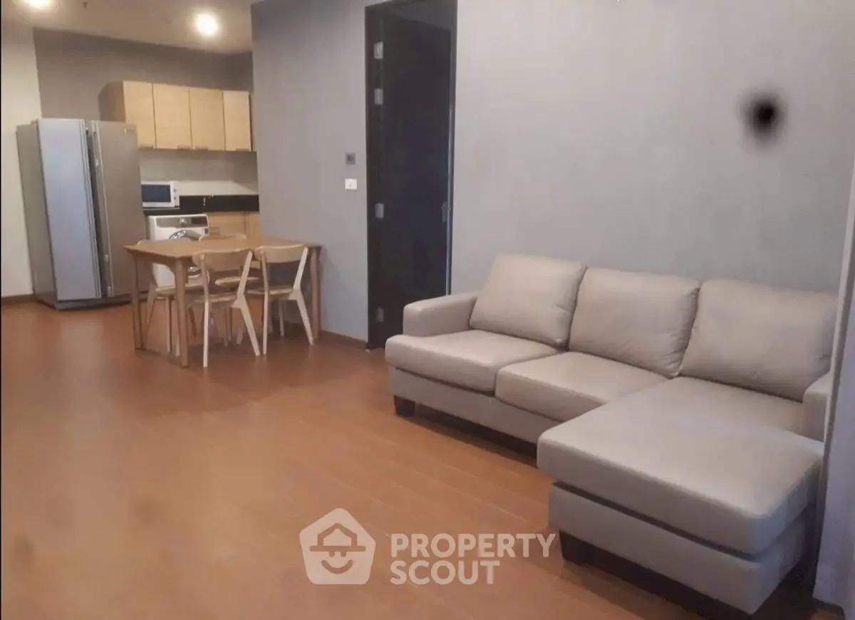 Spacious open-plan living room with modern kitchen and cozy sofa