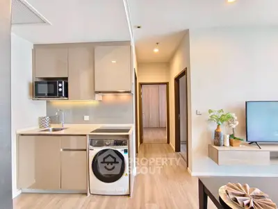 Modern open-plan kitchen and living area with sleek appliances and stylish decor