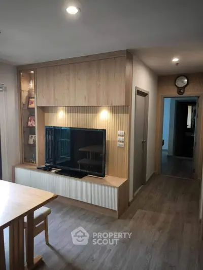 Modern living room with sleek wooden TV unit and cozy ambiance