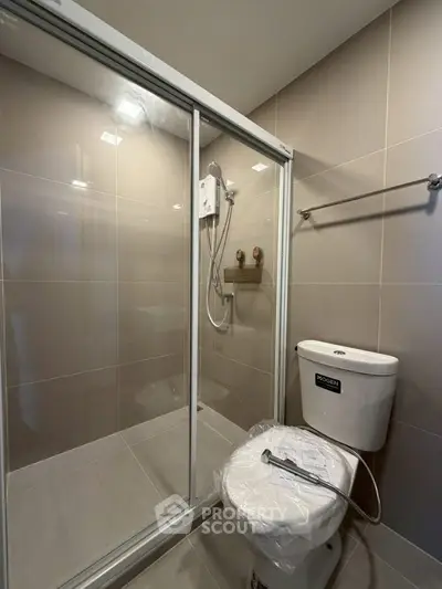 Modern bathroom with sleek shower enclosure and contemporary fixtures.