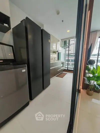 Modern kitchen with sleek appliances and large windows for natural light