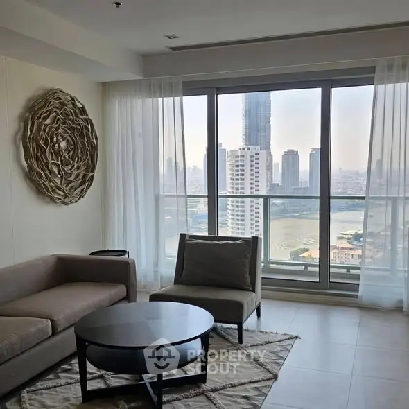Modern living room with stunning city view through large windows, featuring stylish furniture and elegant decor.