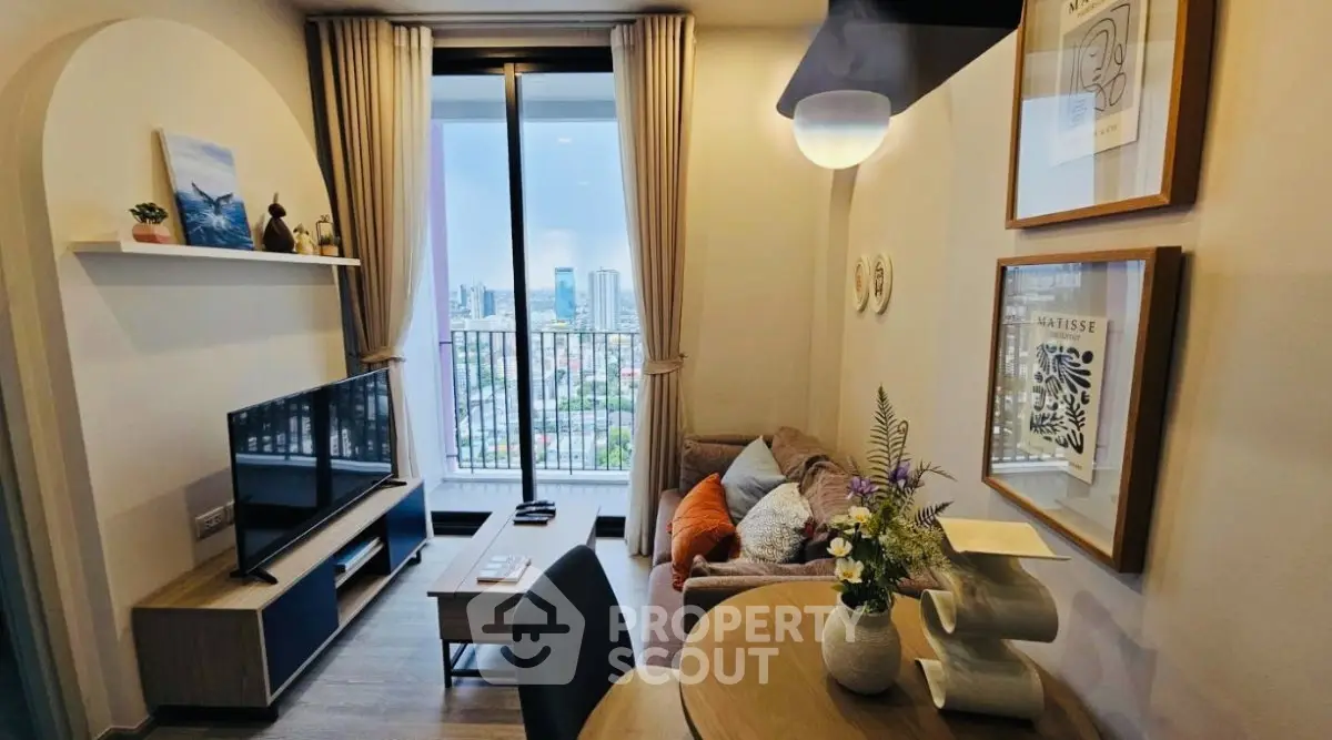 Modern living room with balcony view, stylish decor, and natural light in urban apartment.